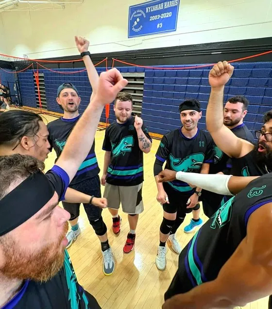 Connecticut Dodgeball players huddled together celebrating